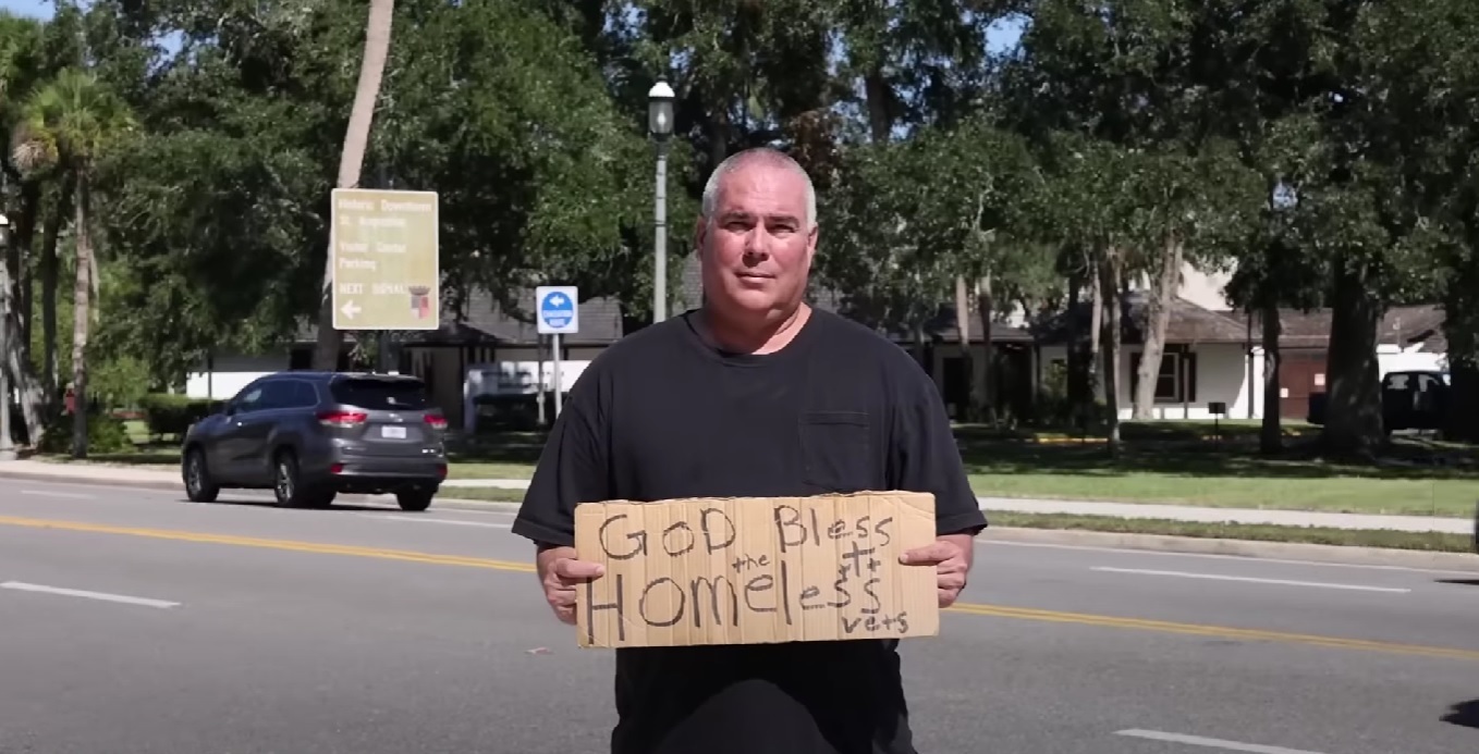 Man arrested for holding God bless the homeless vets sign sues city