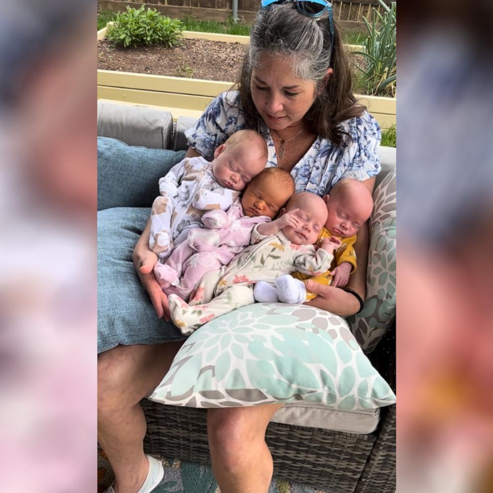 A Texas grandmother holds her  four of her grandchildren adorably.