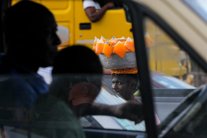 Ghanaian artists and street hawkers team up for a public protest against galamsey.