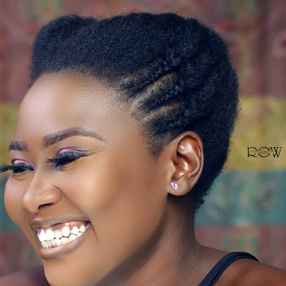 A radiant 23-year-old African lady smiled warmly for a captivating headshot in my studio, her joyful expression lighting up the world 