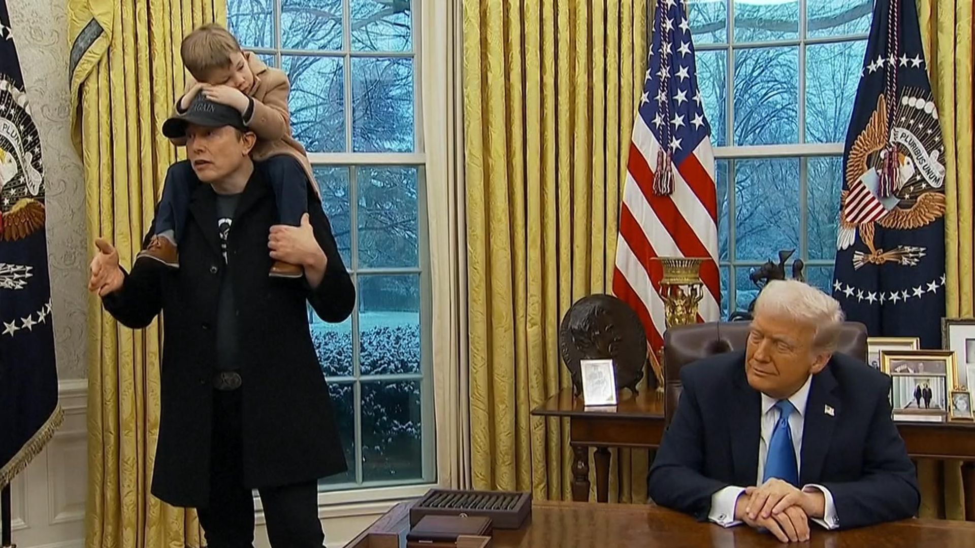 Musk denies 'hostile takeover' of US government - as son sits on his shoulders in Oval Office