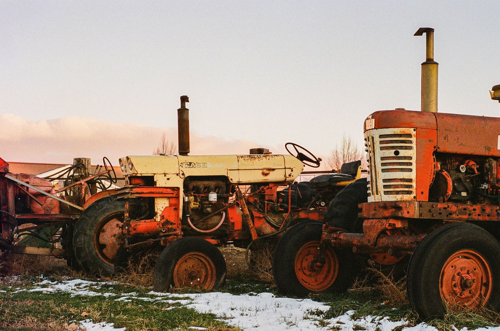 A rusted tractor sleeps in tall grass, / birds perch on its steering wheel....